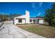 Modern house exterior with a landscaped yard and driveway at 4718 Valley Hill Ct, Lakeland, FL 33813