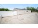 Detached two-car garage with white vinyl fence and concrete driveway for parking at 4718 Valley Hill Ct, Lakeland, FL 33813