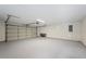 Clean and spacious garage with painted floor and overhead door at 4718 Valley Hill Ct, Lakeland, FL 33813