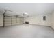 Interior view of garage with overhead lighting and newly painted concrete floor at 4718 Valley Hill Ct, Lakeland, FL 33813