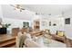 Inviting living room with hardwood floors, ceiling fans, and open layout leading to the kitchen at 4718 Valley Hill Ct, Lakeland, FL 33813