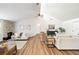 Bright living room featuring vaulted ceilings, stone fireplace, hardwood floors, and comfortable neutral furnishings at 4718 Valley Hill Ct, Lakeland, FL 33813