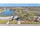 Aerial view of a home with a detached garage and a beautiful waterfront view at 5125 Pheasant Dr, Mulberry, FL 33860