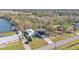 Aerial view of a house, detached garage, and large lot with a lake nearby at 5125 Pheasant Dr, Mulberry, FL 33860