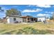 Covered patio with outdoor kitchen and seating area, perfect for entertaining at 5125 Pheasant Dr, Mulberry, FL 33860