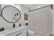 Clean bathroom with a white vanity, round mirror, and a shower/tub combo at 5125 Pheasant Dr, Mulberry, FL 33860