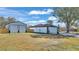 White detached garage with double doors and large yard at 5125 Pheasant Dr, Mulberry, FL 33860