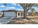 Charming one-story home with white exterior and landscaping at 5125 Pheasant Dr, Mulberry, FL 33860