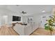 Living room with sectional sofa, hardwood floors, and large TV at 5125 Pheasant Dr, Mulberry, FL 33860