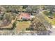 Aerial view highlighting a single-story home with a spacious lot and surrounding trees at 513 E Highland Dr, Lakeland, FL 33813