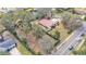 Aerial view showcasing a house with a large yard, located on a tree-lined street at 513 E Highland Dr, Lakeland, FL 33813