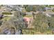 Aerial view of house nestled amongst lush greenery, offering a private backyard at 513 E Highland Dr, Lakeland, FL 33813