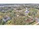 Aerial view showing the house's location in a residential neighborhood with mature trees at 513 E Highland Dr, Lakeland, FL 33813