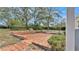 Brick patio and lush landscaping in backyard at 513 E Highland Dr, Lakeland, FL 33813