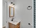 Clean bathroom with wood vanity, modern fixtures, and a large mirror at 513 E Highland Dr, Lakeland, FL 33813