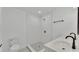 Updated bathroom with white subway tile shower and double vanity at 513 E Highland Dr, Lakeland, FL 33813