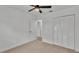 Spacious bedroom with neutral walls, ceiling fan, and built-in closet at 513 E Highland Dr, Lakeland, FL 33813