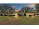 Ranch style home with large green door and mature trees at 513 E Highland Dr, Lakeland, FL 33813