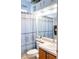 Light blue bathroom with shower and mirror at 518 Grand Reserve Dr, Davenport, FL 33837