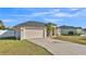 House with a garage and landscaping at 5181 Ashwood Dr, Lakeland, FL 33811