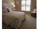 Bedroom featuring bright natural light from the window, a bed with pink accents, and neutral carpeting at 5269 Pebble Beach Blvd, Winter Haven, FL 33884