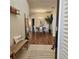 Bright entryway with wood floors, a bench, and views into the dining area at 5269 Pebble Beach Blvd, Winter Haven, FL 33884