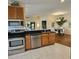 Spacious kitchen with stainless steel appliances and wood cabinets at 5269 Pebble Beach Blvd, Winter Haven, FL 33884