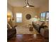 Living room with wood floors, a sofa, and access to a screened patio at 5269 Pebble Beach Blvd, Winter Haven, FL 33884