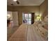 Bedroom with decorative pillows, ceiling fan, and access to the lanai through sliding glass doors at 5269 Pebble Beach Blvd, Winter Haven, FL 33884