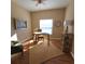 Bright home office features hardwood floors, a ceiling fan, and a sunny window with natural light at 5269 Pebble Beach Blvd, Winter Haven, FL 33884