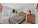 Serene bedroom with wooden bed frame and rustic wall decor at 5440 Siltstone St, Lakeland, FL 33811