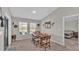 Bright dining room features a rustic wood table with seating for six and view into the kitchen at 5440 Siltstone St, Lakeland, FL 33811