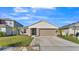 Single-story home with a two-car garage and landscaped lawn at 5440 Siltstone St, Lakeland, FL 33811