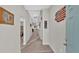 Inviting hallway with neutral tones, carpet flooring and stylish decor leading to the bedrooms at 5440 Siltstone St, Lakeland, FL 33811