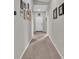 Long hallway with neutral walls and carpeted floors at 5440 Siltstone St, Lakeland, FL 33811