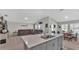 Open kitchen with island, stainless steel appliances, and views of living room at 5440 Siltstone St, Lakeland, FL 33811