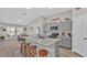 Modern kitchen with gray cabinets, a large island, and stainless steel appliances at 5440 Siltstone St, Lakeland, FL 33811