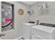 Nice laundry room with washer, dryer, and shelving at 5440 Siltstone St, Lakeland, FL 33811