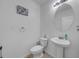 Small bathroom with pedestal sink and toilet at 5557 Oro Valley Rd, Auburndale, FL 33823