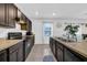 Modern kitchen with dark brown cabinets and stainless steel appliances at 5557 Oro Valley Rd, Auburndale, FL 33823