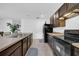 Modern kitchen with dark brown cabinets and stainless steel appliances at 5557 Oro Valley Rd, Auburndale, FL 33823