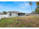 Spacious backyard with a screened porch, providing ample outdoor space at 5819 Driftwood Dr, Winter Haven, FL 33884