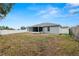 Large backyard with a screened-in patio and a wooden fence at 5819 Driftwood Dr, Winter Haven, FL 33884