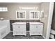 Bathroom with double vanity and gray tile backsplash at 5819 Driftwood Dr, Winter Haven, FL 33884