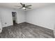 Bedroom with ceiling fan and wood-look floors at 5819 Driftwood Dr, Winter Haven, FL 33884