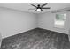 Bright bedroom with ceiling fan and wood-look floors at 5819 Driftwood Dr, Winter Haven, FL 33884