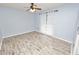 Spacious bedroom with light walls, wood-look floors, and a ceiling fan at 5819 Driftwood Dr, Winter Haven, FL 33884