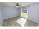 Spacious bedroom featuring wood-look floors and large window at 5819 Driftwood Dr, Winter Haven, FL 33884