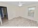 Bedroom with ceiling fan and window with blinds at 5819 Driftwood Dr, Winter Haven, FL 33884