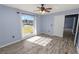 Bright bedroom with wood-look floors and large window at 5819 Driftwood Dr, Winter Haven, FL 33884